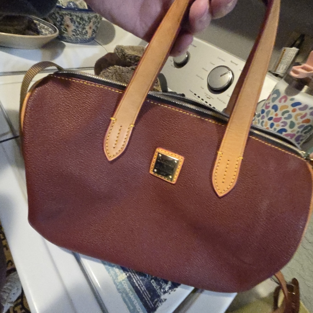 Dooney and Burke burgundy purse medium size.